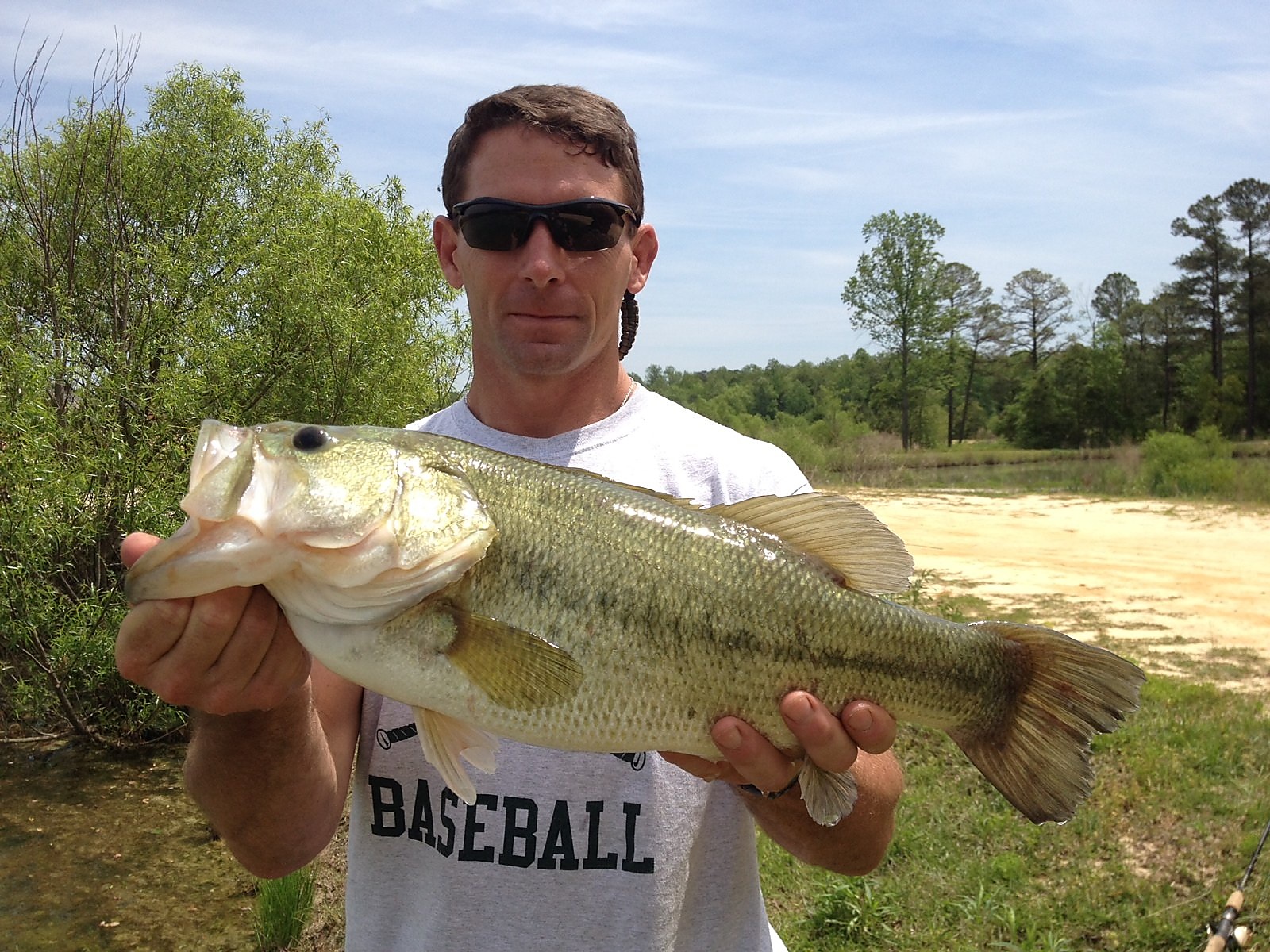 Charles Masaracchia holding a bass outdoors