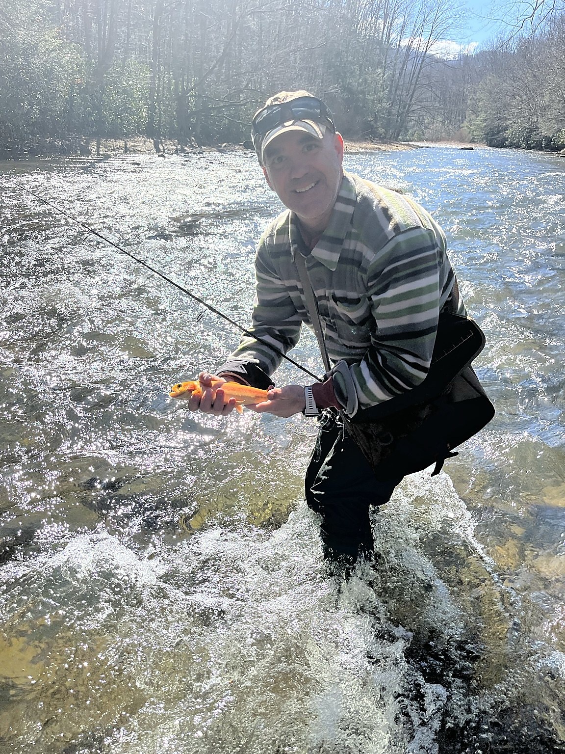 Dustin Menhart fishing in a mountain stream